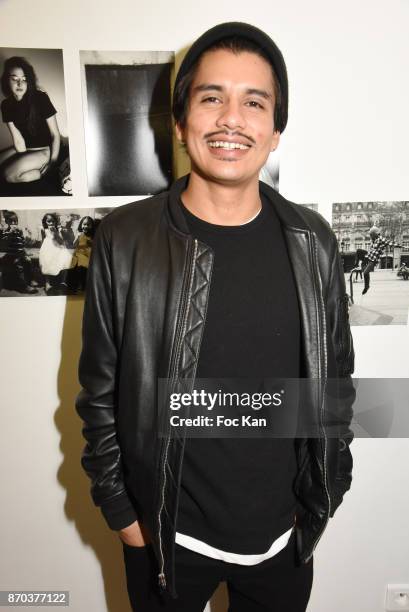 Photographer/musician Jonathan Velasquez pose with his personal work during the Larry Clark and Jonathan Velasquez Photo Exhibition as part of Larry...