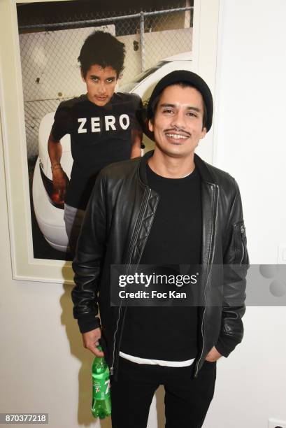 Photographer/musician Jonathan Velasquez poses with his portraits by Larry Clark during the Larry Clark and Jonathan Velasquez Photo Exhibition as...