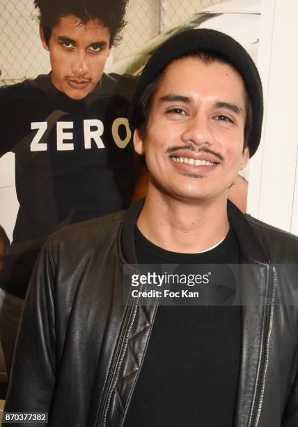 Photographer/musician Jonathan Velasquez posess with his portraits by Larry Clark during the Larry Clark and Jonathan Velasquez Photo Exhibition as...