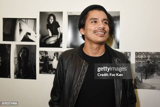 Photographer/musician Jonathan Velasquez poses with his personal work during the Larry Clark and Jonathan Velasquez Photo Exhibition as part of Larry...