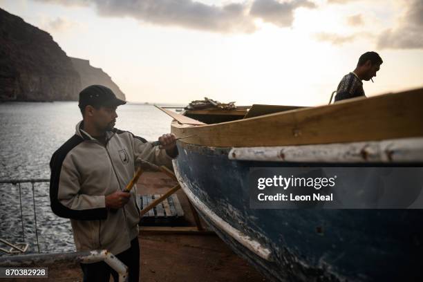 Fishermen Robin Stander and Wayne Yon continue renovation work on the boat "Tina" on October 23, 2017 in Jamestown, Saint Helena. The waters around...