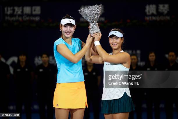 Yingying Duan and Xinyun Han of China celebrate with the trophy following their victory during the Ladies Doubles final against Shuai Zhang and...