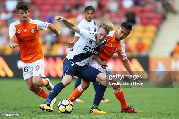 Andrew Hoole of the Mariners and Dane Ingham of the Roar compete for the ball during the round five A-League match between the Brisbane Roar and the...