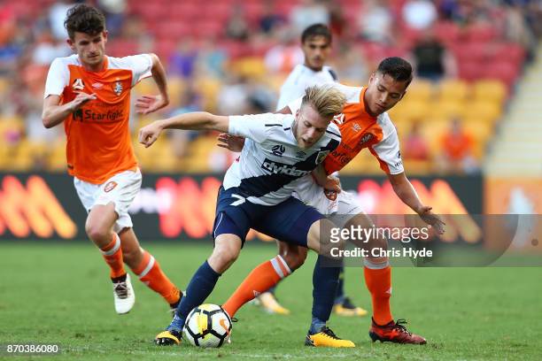 Andrew Hoole of the Mariners and Dane Ingham of the Roar compete for the ball during the round five A-League match between the Brisbane Roar and the...