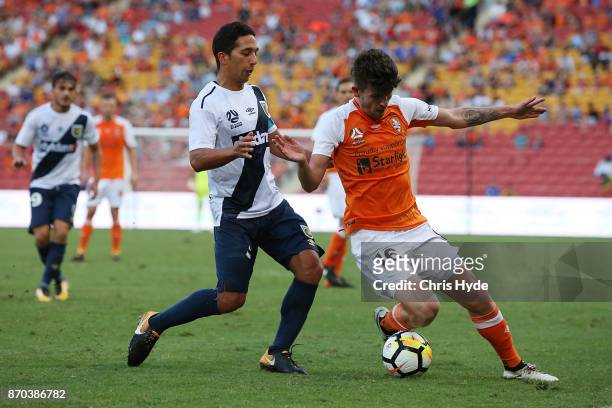 Tom Hiariej of the Mariners and Mitchell Oxborrow of the Roar competes for the ball during the round five A-League match between the Brisbane Roar...