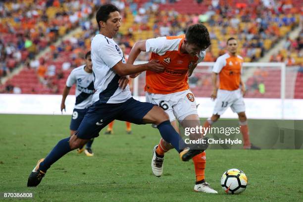 Tom Hiariej of the Mariners and Mitchell Oxborrow of the Roar competes for the ball during the round five A-League match between the Brisbane Roar...