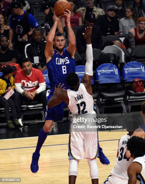 Danilo Gallinari of the Los Angeles Clippers passes the ball as he is pressured by James Ennis III of the Memphis Grizzlies during the first half of...