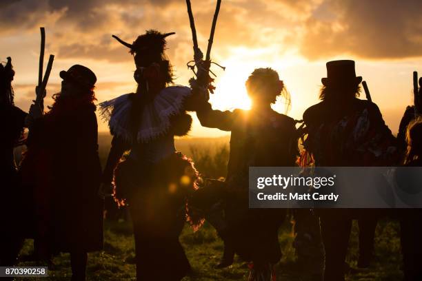 The Glastonbury Border Morris dance at sunset as they celebrate Samhain at the Glastonbury Dragons Samhain Wild Hunt 2017 in Glastonbury on November...