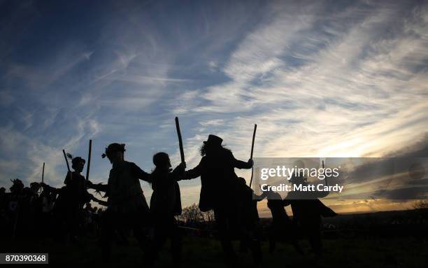 The Glastonbury Border Morris dance at sunset as they celebrate Samhain at the Glastonbury Dragons Samhain Wild Hunt 2017 in Glastonbury on November...