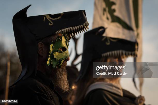 People take part in a sunset ceremony on the lower slopes of Glastonbury Tor as they celebrate Samhain at the Glastonbury Dragons Samhain Wild Hunt...