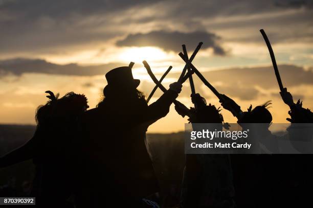 The Glastonbury Border Morris dance at sunset as they celebrate Samhain at the Glastonbury Dragons Samhain Wild Hunt 2017 in Glastonbury on November...