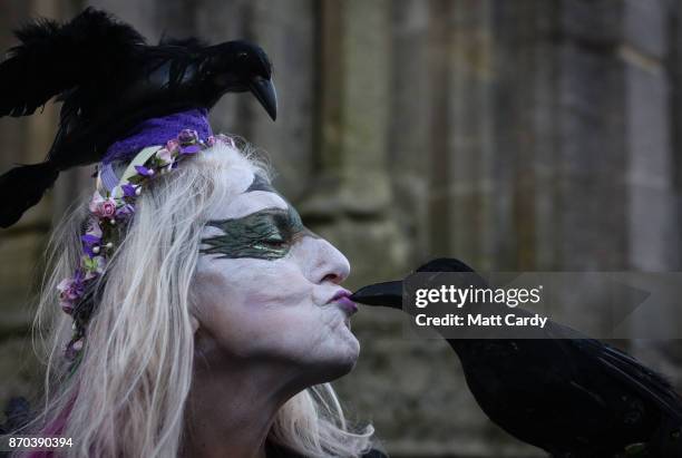 People gather at the Glastonbury Market Cross as they celebrate Samhain at the Glastonbury Dragons Samhain Wild Hunt 2017 in Glastonbury on November...