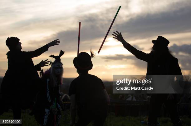 The Glastonbury Border Morris dance at sunset as they celebrate Samhain at the Glastonbury Dragons Samhain Wild Hunt 2017 in Glastonbury on November...