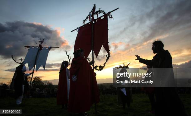 People take part in a sunset ceremony as they celebrate Samhain at the Glastonbury Dragons Samhain Wild Hunt 2017 in Glastonbury on November 4, 2017...