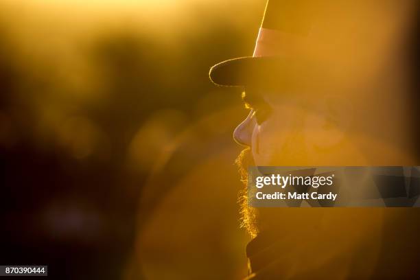 People take part in a sunset ceremony on the lower slopes of Glastonbury Tor as they celebrate Samhain at the Glastonbury Dragons Samhain Wild Hunt...