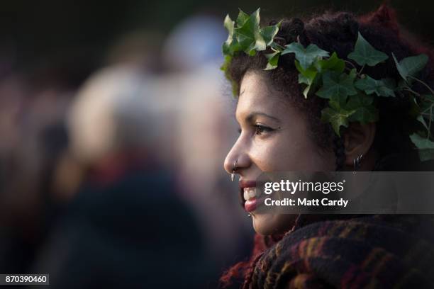 People take part in a sunset ceremony on the lower slopes of Glastonbury Tor as they celebrate Samhain at the Glastonbury Dragons Samhain Wild Hunt...