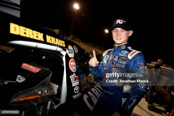 Derek Kraus, driver of the Carlyle Tools Toyota, places the winner's decal on his car after winning the NASCAR K&N Pro Series West Coast Stock Car...