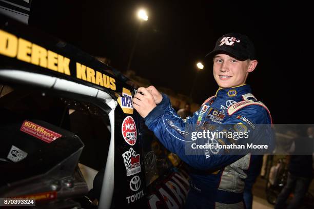 Derek Kraus, driver of the Carlyle Tools Toyota, places the winner's decal on his car after winning the NASCAR K&N Pro Series West Coast Stock Car...
