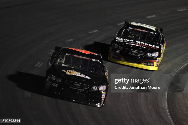 Dillon Bassett, driver of the Bassett Gutters and More Toyota, and Bill Kann, driver of the Kevin Grover GMC Toyota, race on track during the NASCAR...