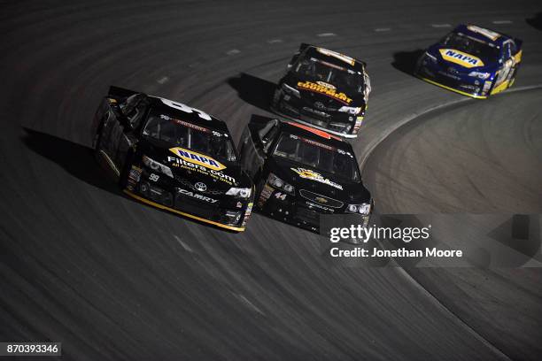 Chris Eggleston, driver of the NAPA Filters Toyota, and Dillon Bassett, driver of the Bassett Gutters and More Toyota, race on track during the...