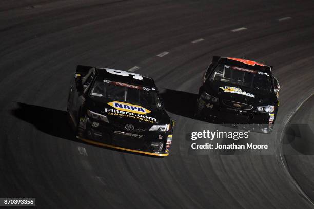 Chris Eggleston, driver of the NAPA Filters Toyota, and Dillon Bassett, driver of the Bassett Gutters and More Toyota, race on track during the...