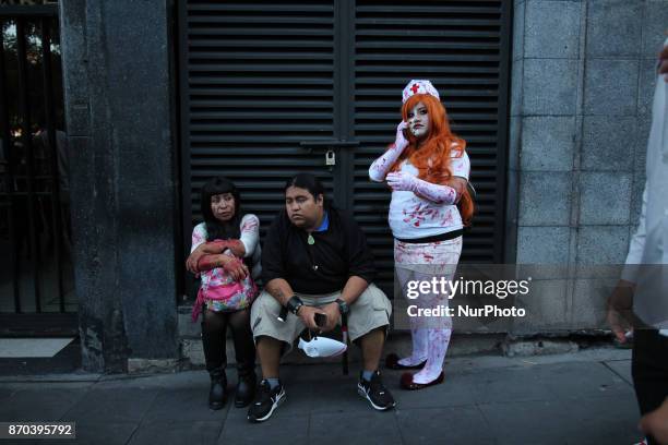 Woman painted an disgused as a zombie nurse during the annual procession of zombies in Mexico City on November 4, 2017. Hundreds dressed in rags and...