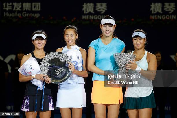 Winners Yingying Duan and Xinyun Han of China with runners-up Shuai Zhang and Jingjing Lu of China pose with their trophies following the Ladies...