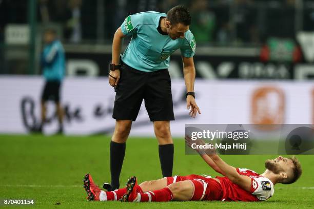 Alexandru Maxim of Mainz reacts next to a referee during the Bundesliga match between Borussia Moenchengladbach and 1. FSV Mainz 05 at Borussia-Park...