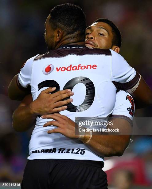 Taane Milne of Fiji is congratulated by Salesi Faingaa after scoring a try during the 2017 Rugby League World Cup match between Fiji and Wales at...