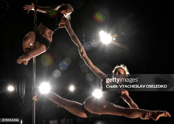 Participants perform a routine during the "Kyrgyzstan Pole Sport Championship 2017" competition in Bishkek, on November 4, 2017. Contestants from...