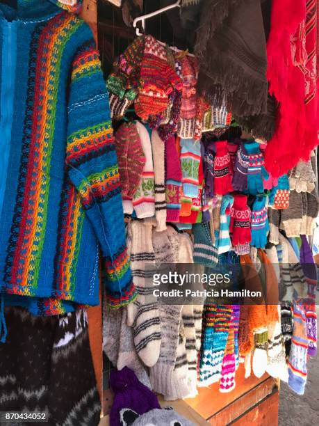 clothing made from llama wool at a chilean market stall. - aysén del general carlos ibáñez del campo stock pictures, royalty-free photos & images