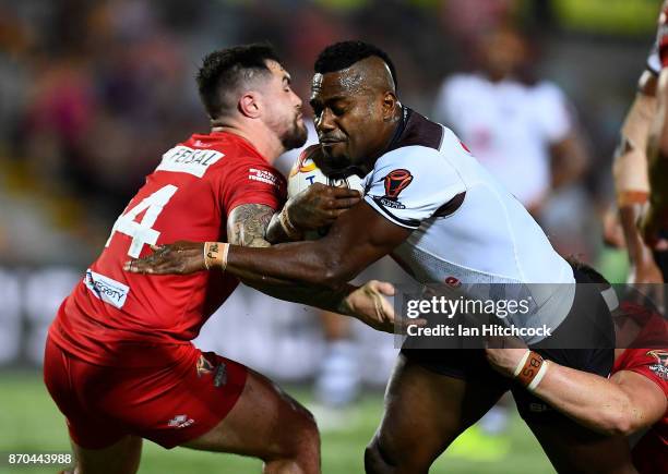 Akuila Uate of Fiji is tackled by Matty Fozard and Morgan Knowles of Wales during the 2017 Rugby League World Cup match between Fiji and Wales at...