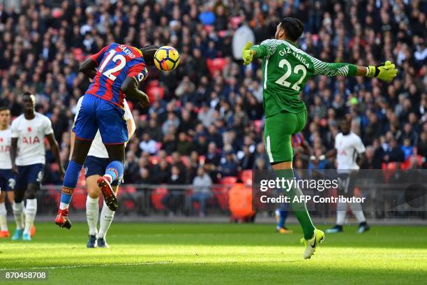 Crystal Palace's French midfielder Mamadou Sakho shoots but fails to score against Tottenham Hotspur's Argentinian goalkeeper Paulo Gazzaniga during...