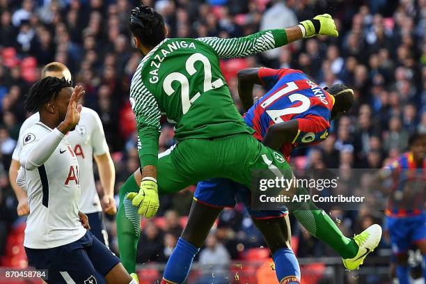 Crystal Palace's French midfielder Mamadou Sakho shoots but fails to score against Tottenham Hotspur's Argentinian goalkeeper Paulo Gazzaniga during...