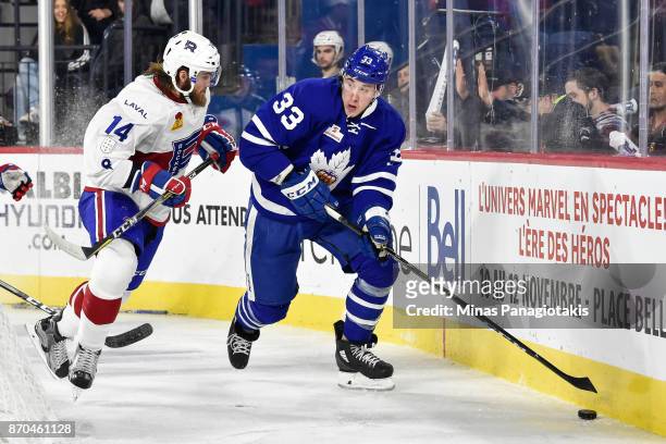 Frederik Gauthier of the Toronto Marlies skates the puck against Brett Lernout of the Laval Rocket during the AHL game at Place Bell on November 1,...