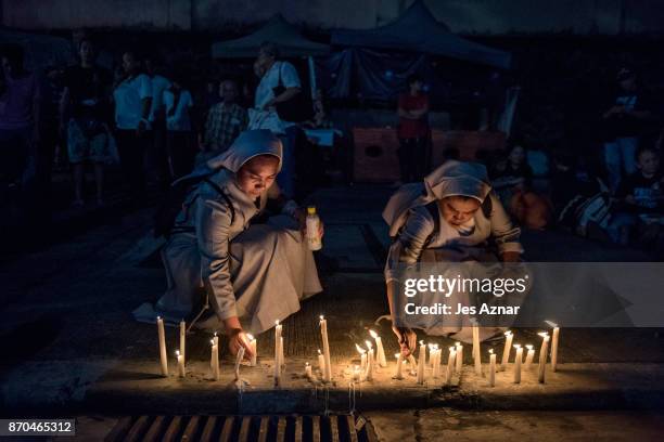 Nuns light candles as they join a prayer protest calling to an end to drug-related killings on November 5, 2017 in Manila, Philippines. Philippine...