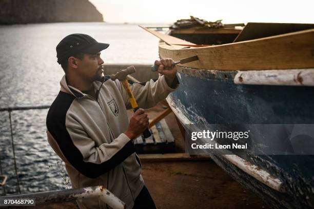 Fisherman Robin Stander continues renovation work on the boat "Tina" on October 23, 2017 in Jamestown, Saint Helena. The waters around the island...
