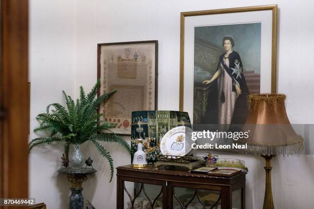 Portrait of Britain's Queen Elizabeth II hangs above various Royal ornaments in the Consulate Hotel on October 24, 2017 in Jamestown, Saint Helena....