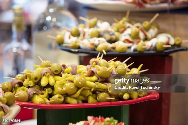 famous bilbao small sandwiches called pintxos server from a bar counter, blibao - bar counter traditional stock-fotos und bilder