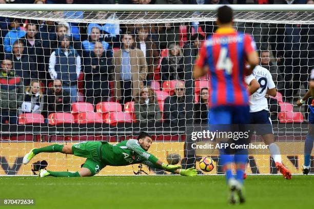 Tottenham Hotspur's Argentinian goalkeeper Paulo Gazzaniga dives to save a shot from Crystal Palace's English midfielder Andros Townsend during the...