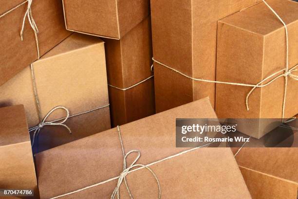 brown cardboard boxes, tied with strings, full frame. - plain packaging stock pictures, royalty-free photos & images