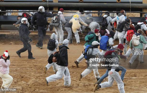 Riot police with pepper spray attempt to stop climate activists from the group "Ende Gelaende" charging into the Hambach open-pit coal mine on...