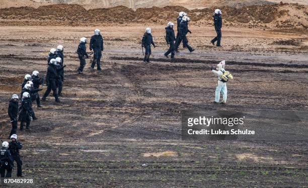 Police blocks environmental protesters at the open-cast brown coal mining Hambach on November 5, 2017 near Kerpen, Germany. The protest, part of a...