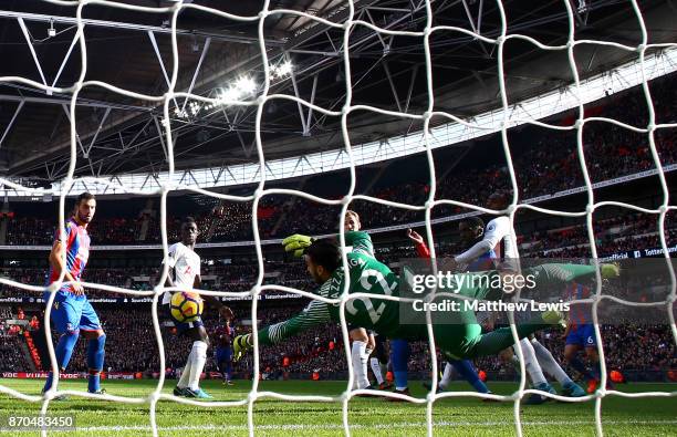 Paulo Gazzaniga of Tottenham Hotspur saves a shot from Jeffrey Schlupp of Crystal Palace during the Premier League match between Tottenham Hotspur...