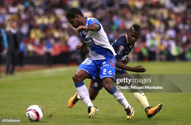 Darwin Quintero of America competes for the ball with Brayan Angulo of Puebla during the 16th round match between America and Puebla as part of the...