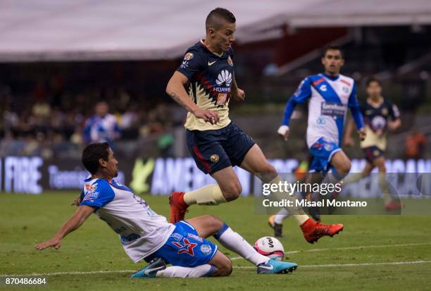 Andres Andrade of America fights for the ball with Patricio Araujo of Puebla during the 16th round match between America and Puebla as part of the...