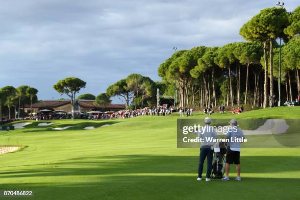 Dylan Frittelli of South Africa looks down the 18th hole with caddie John Curtis during the final round of the Turkish Airlines Open at the Regnum...