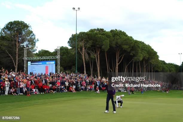 Justin Rose of England acknowledges the crowd after a birdie on the 18th green during the final round of the Turkish Airlines Open at the Regnum...