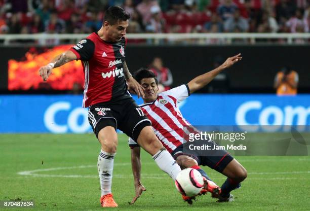 Milton Caraglio of Atlas and Jesus Sanchez of Chivas fight for the ball during the 17th round match between Chivas and Atlas as part of the Torneo...