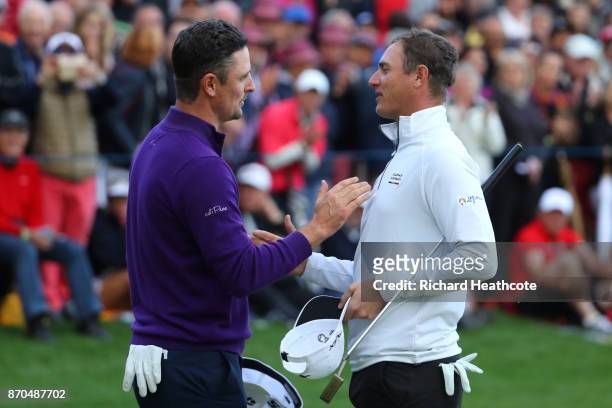 Justin Rose of England is congratulated by Nicolas Colsaerts of Belgium on the 18th green during the final round of the Turkish Airlines Open at the...
